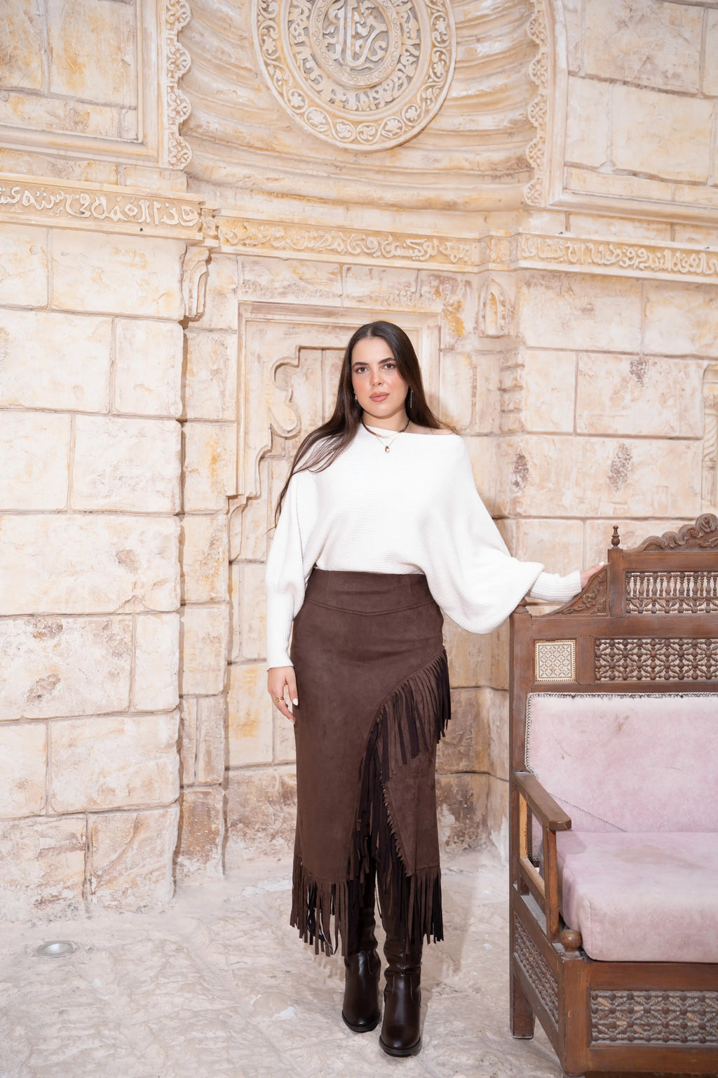 Model wearing brown suede fringe midi skirt with high-waisted fit