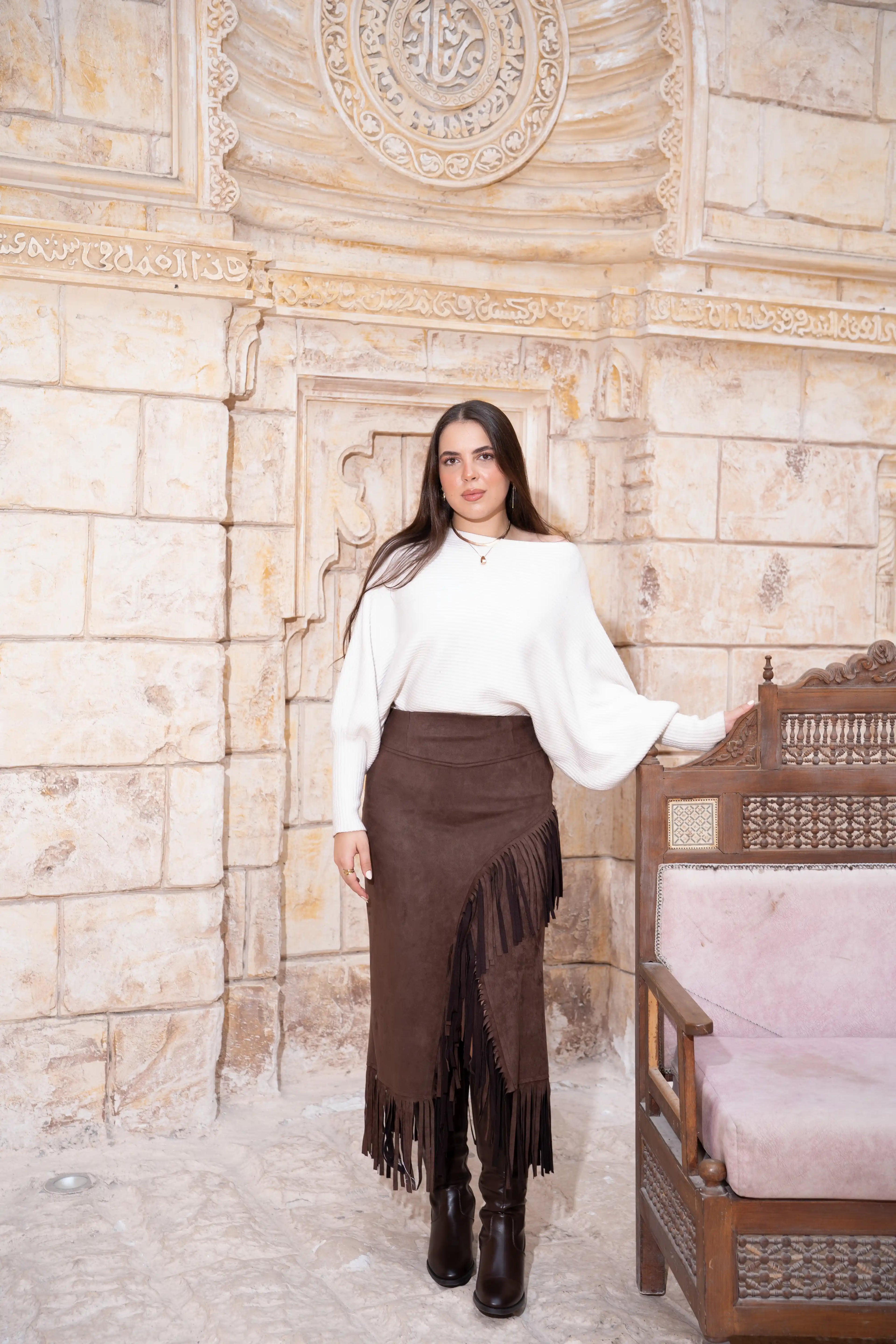 Model wearing brown suede fringe midi skirt with high-waisted fit