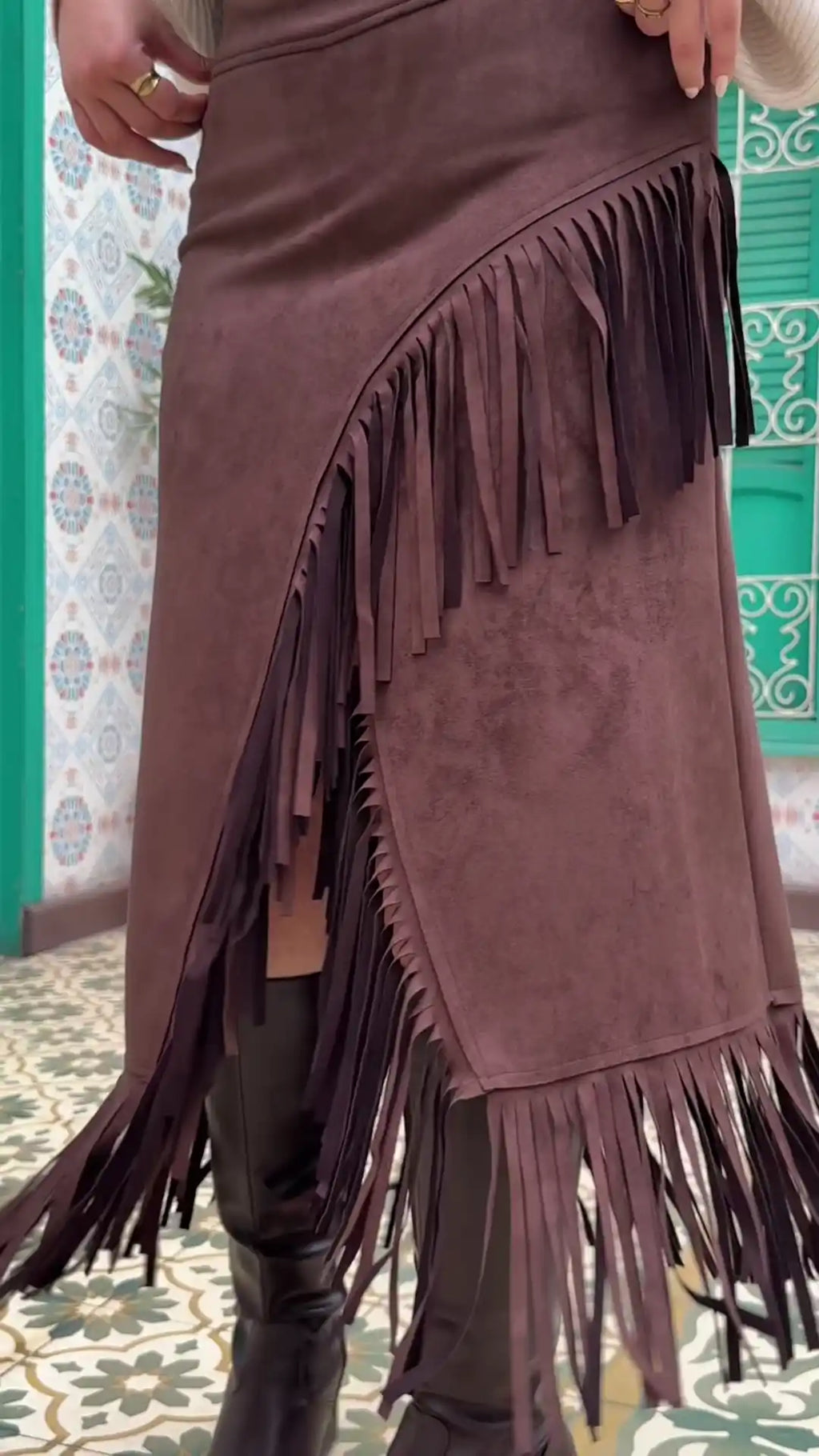 Close-up of brown suede skirt fringe trimming and suede texture